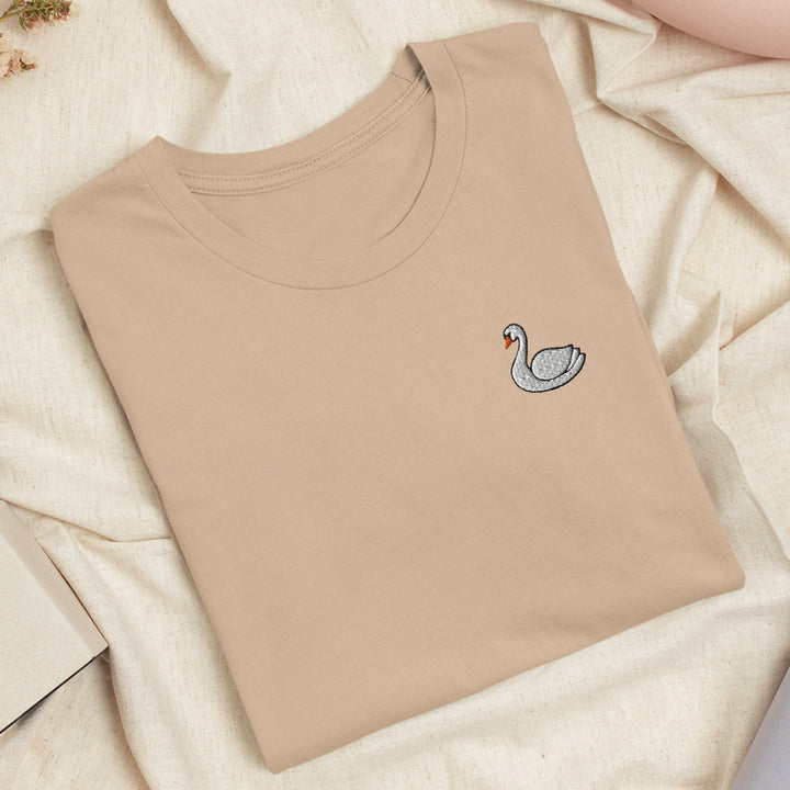 a t - shirt with a swan embroidered on it