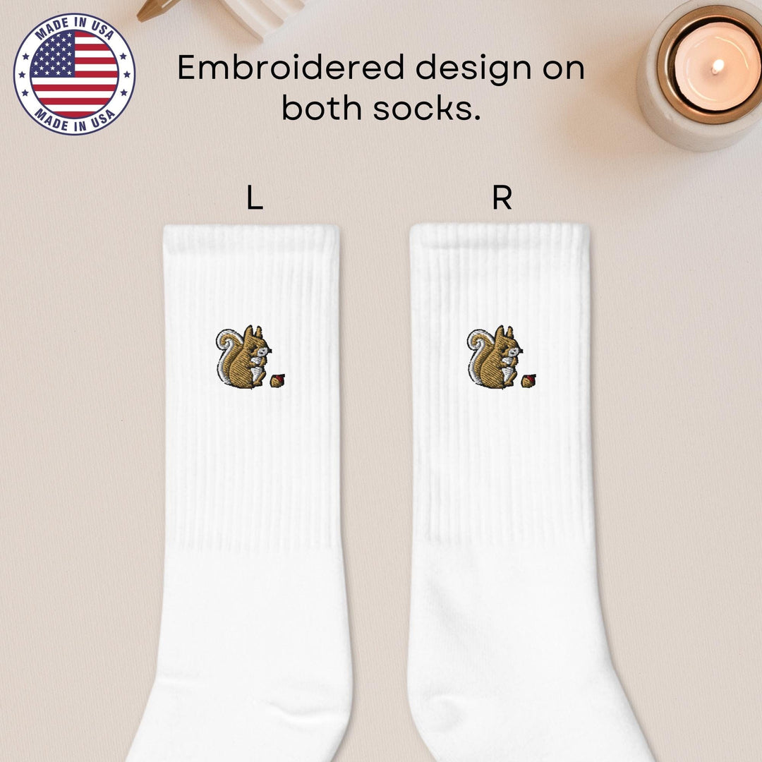 a pair of white socks with a squirrel on it