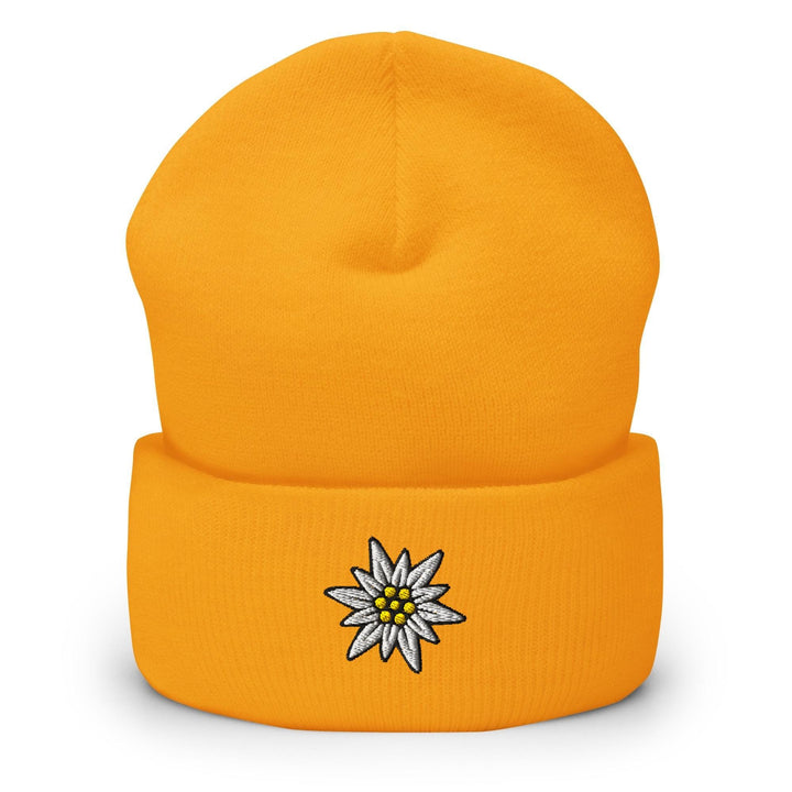 a yellow beanie with a white flower on it
