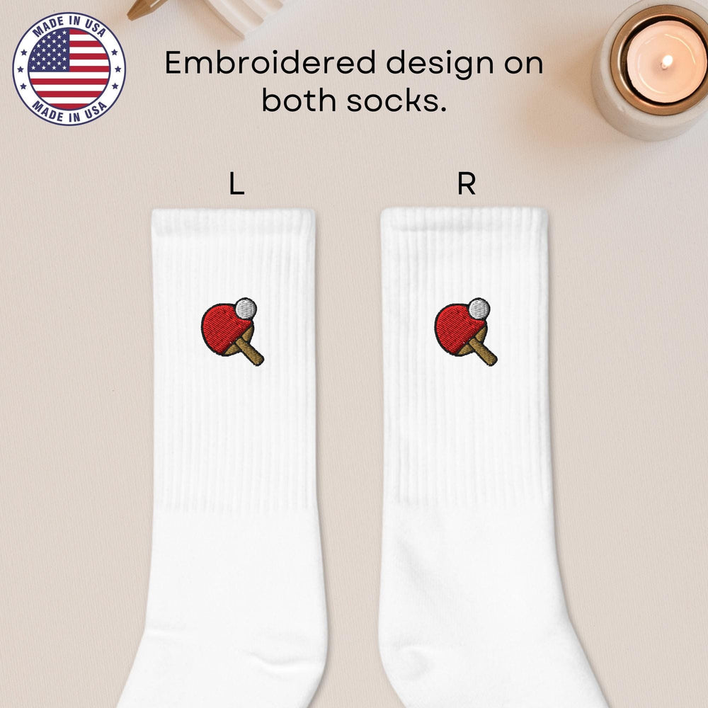 a pair of white socks with an apple on them