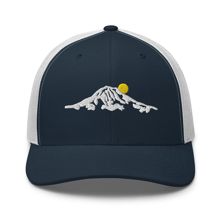 a blue and white trucker hat with a mountain design
