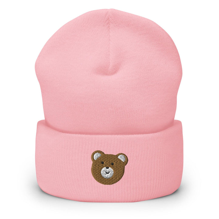 a pink beanie with a brown teddy bear on it
