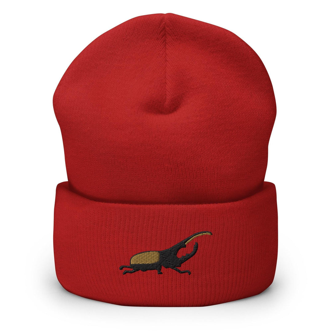 a red beanie with a small black animal on it