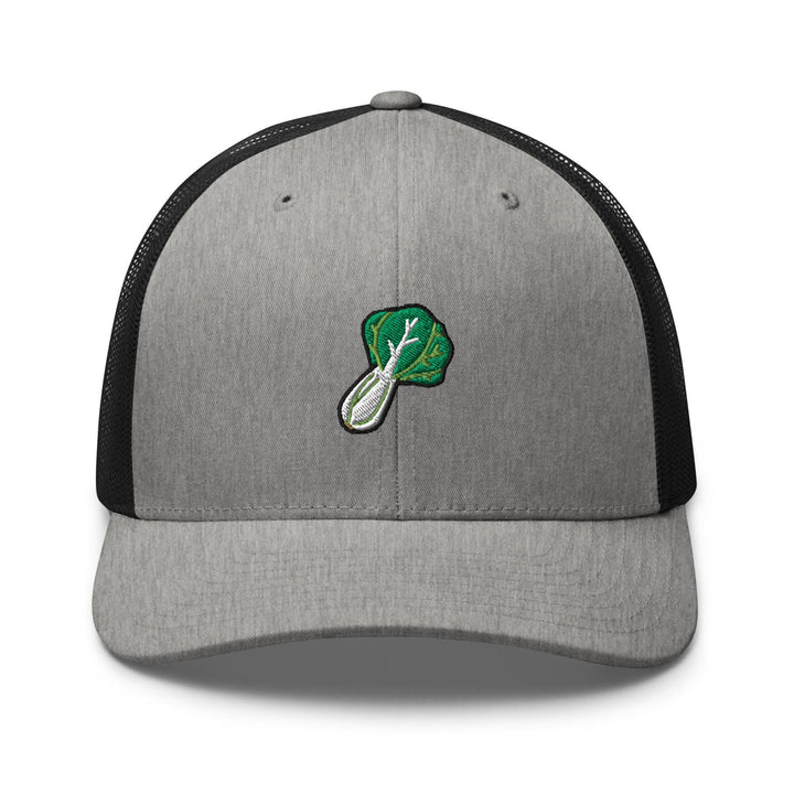 a gray and black trucker hat with a green leaf on it