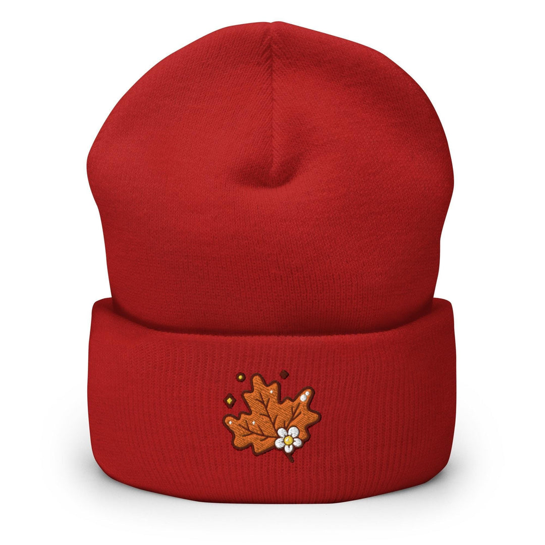 a red beanie with a maple leaf embroidered on it