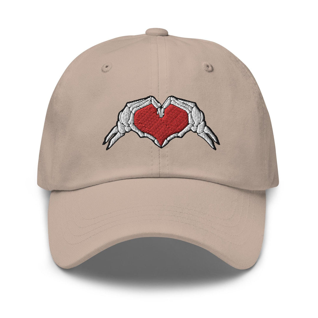 a baseball cap with a heart and wings embroidered on it