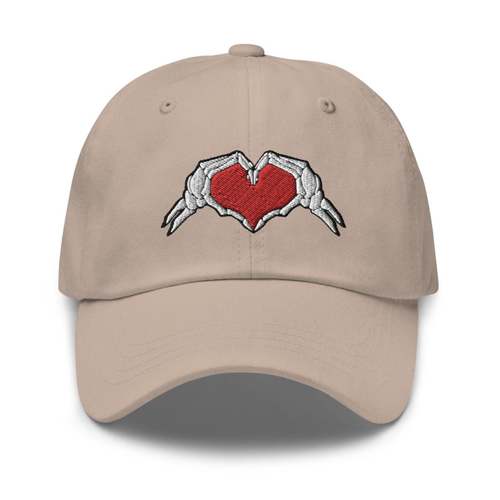 a baseball cap with a heart and wings embroidered on it