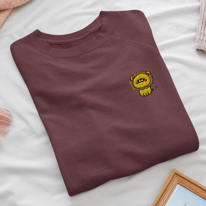 a brown t - shirt with a yellow bear on it