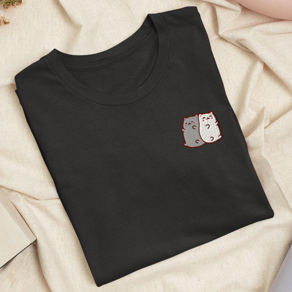 a black t - shirt with a cat pocket on it