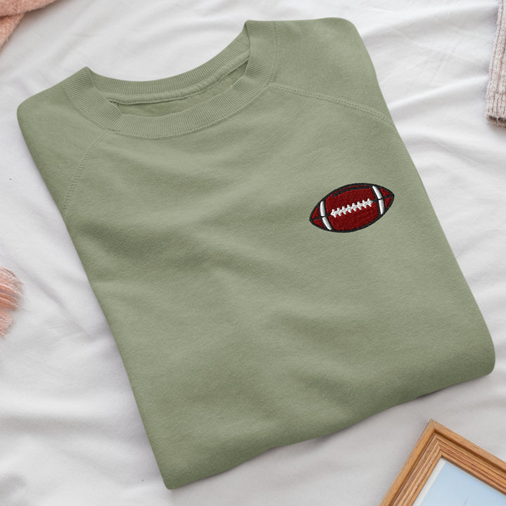 a t - shirt with a football embroidered on it