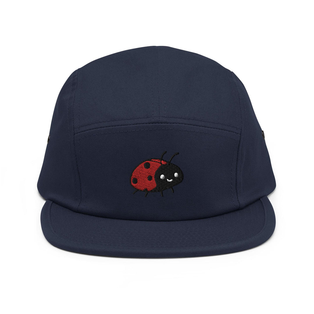a blue hat with a red ladybug embroidered on it