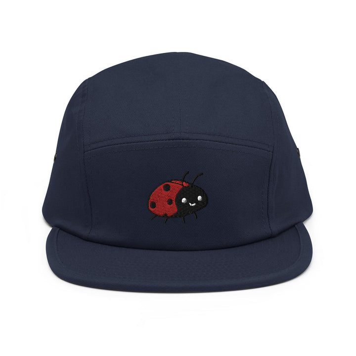 a blue hat with a red ladybug embroidered on it