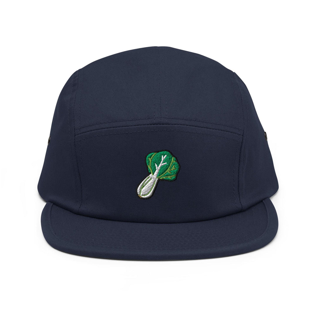 a blue hat with a green leaf on it
