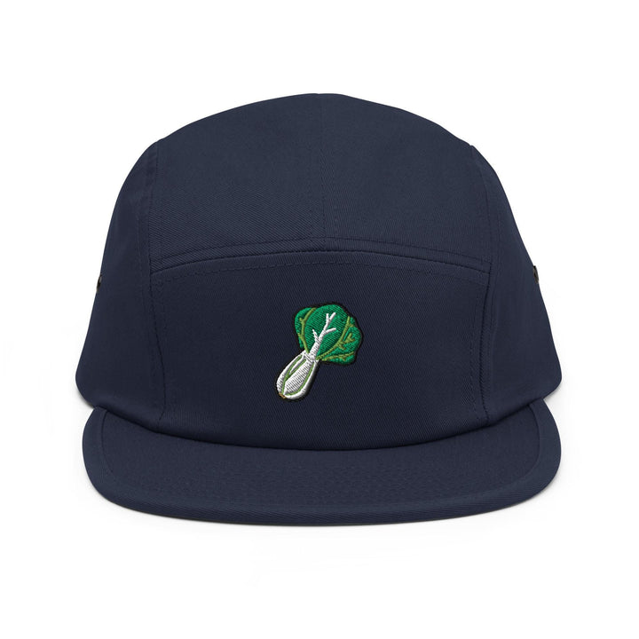 a blue hat with a green leaf on it