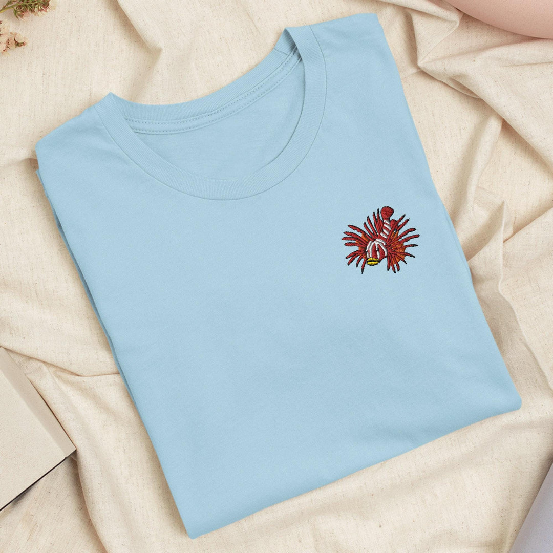 a blue t - shirt with a red flower on it