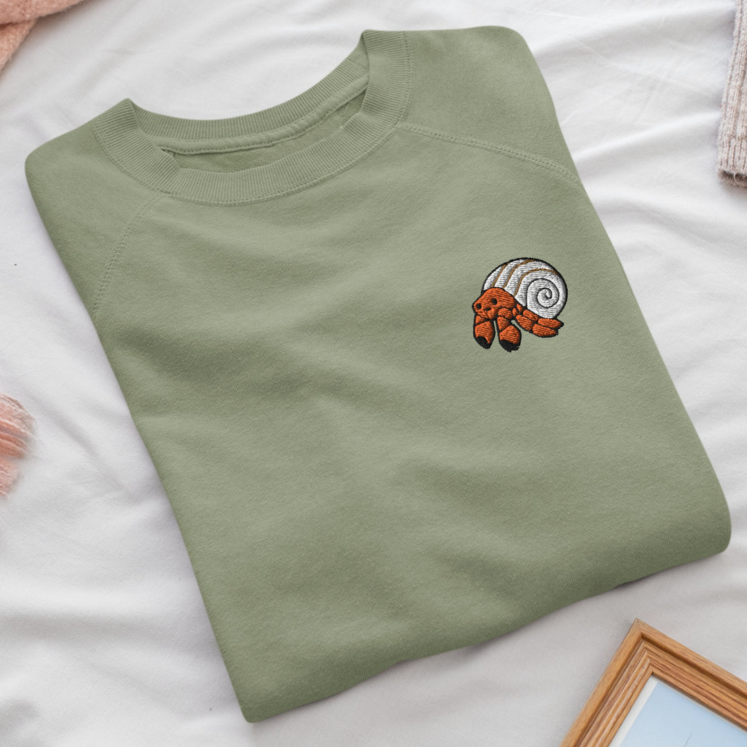 a green t - shirt with a picture of a snail on it