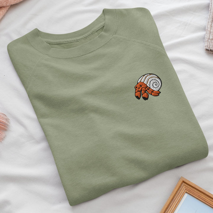 a green t - shirt with a picture of a snail on it