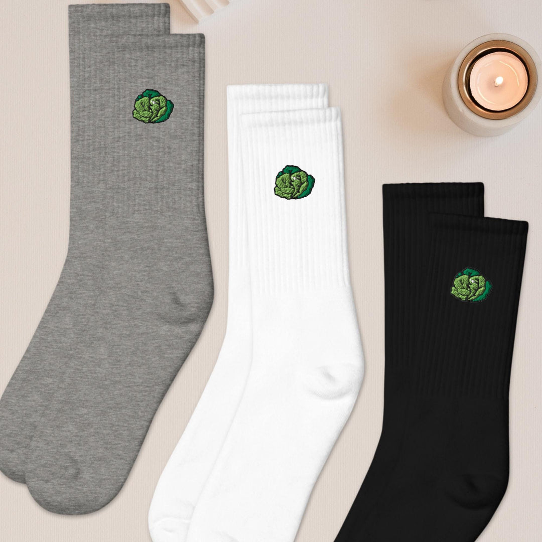 three pairs of socks sitting on top of a table