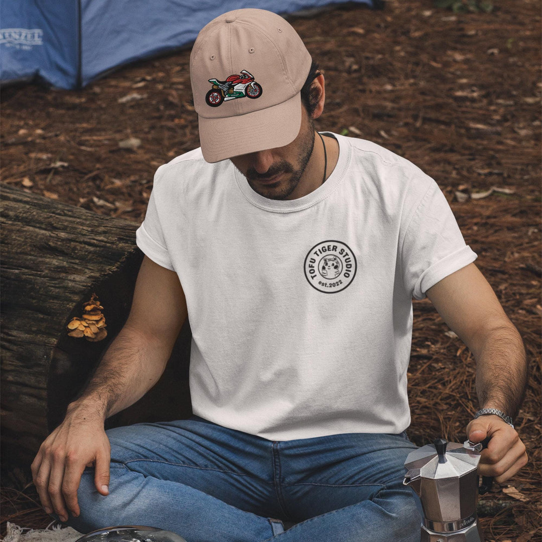 a man sitting on the ground next to a cup