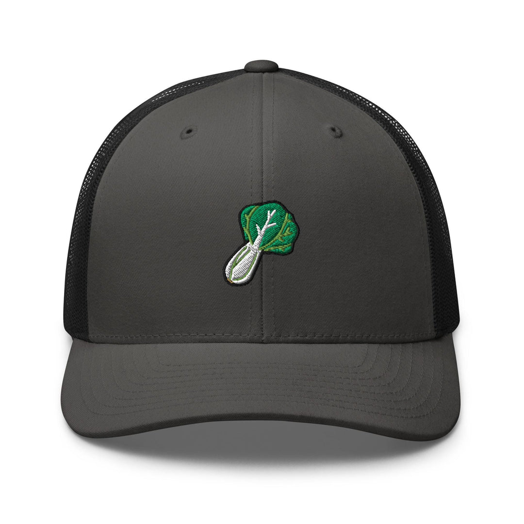 a gray and black trucker hat with a green leaf on it