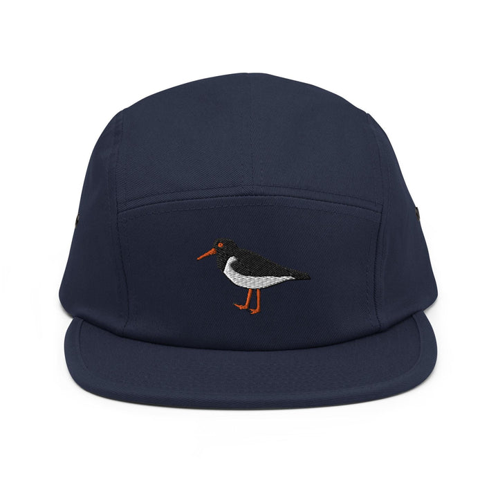 a blue hat with a bird embroidered on it