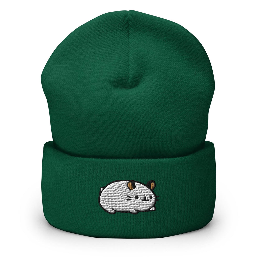 a green beanie with a cartoon cow on it