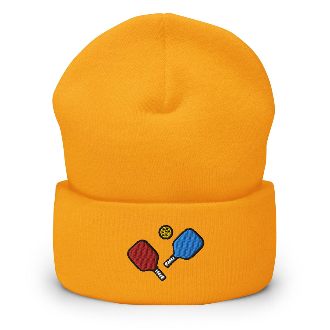 a yellow beanie with two ping pong paddles on it