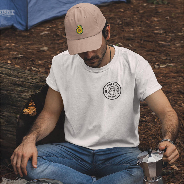 a man sitting on the ground with a cup of coffee