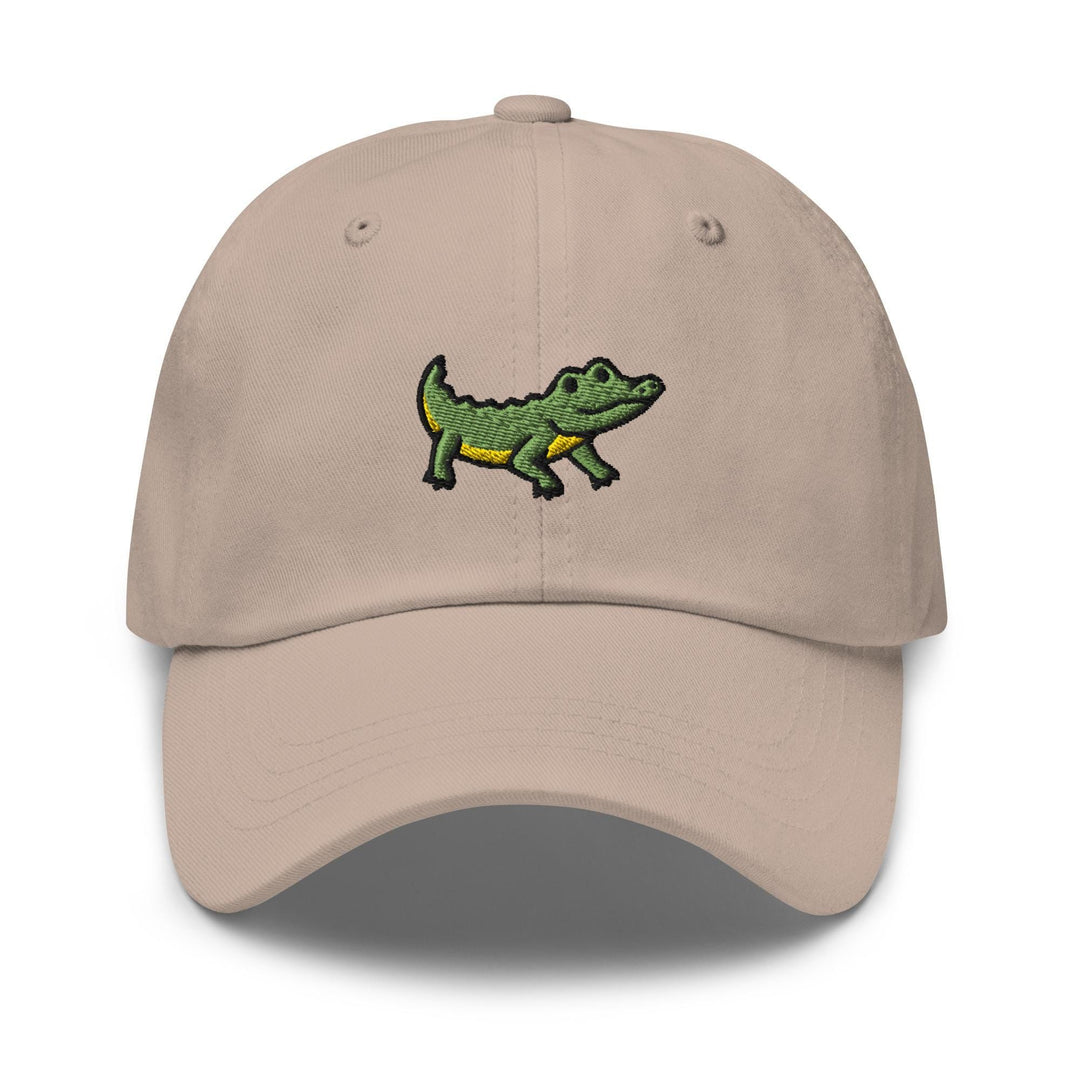 a tan hat with a green alligator embroidered on it