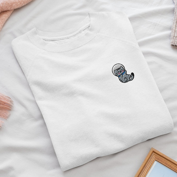 a white t - shirt with a picture of a cat on it