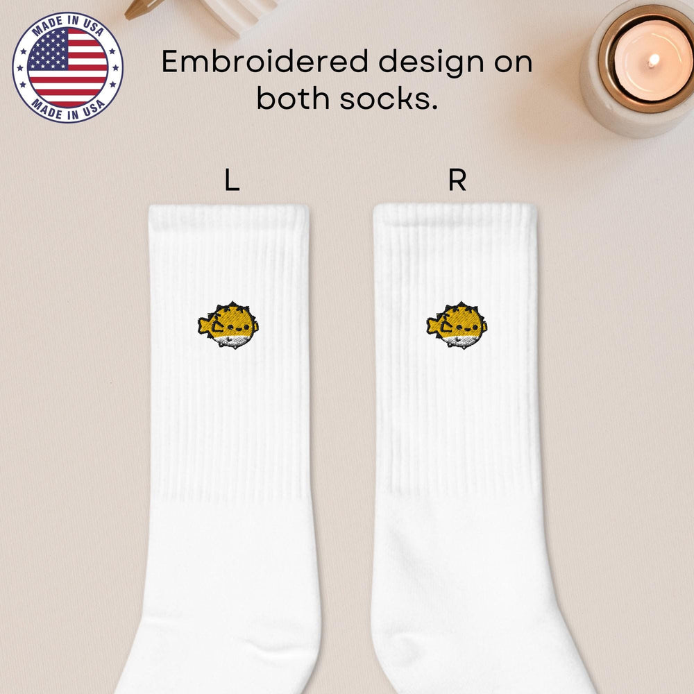 a pair of white socks with a picture of a cat on it