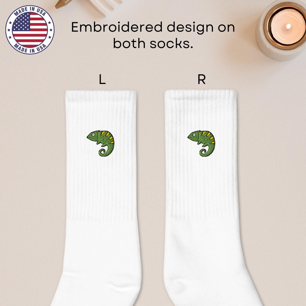 a pair of white socks with a green snake on them
