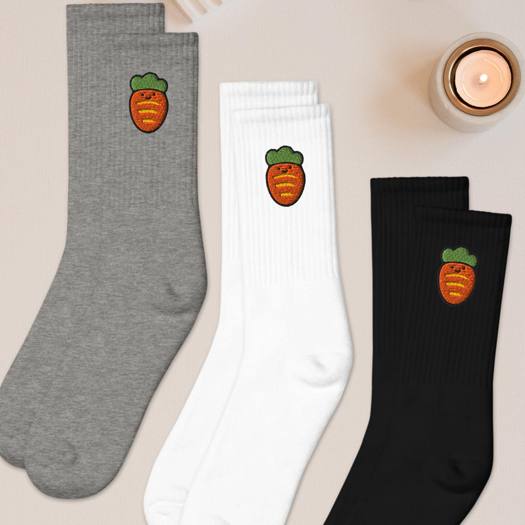 three pairs of socks with carrots on them