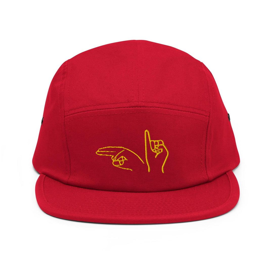 a red hat with a yellow hand drawn on it