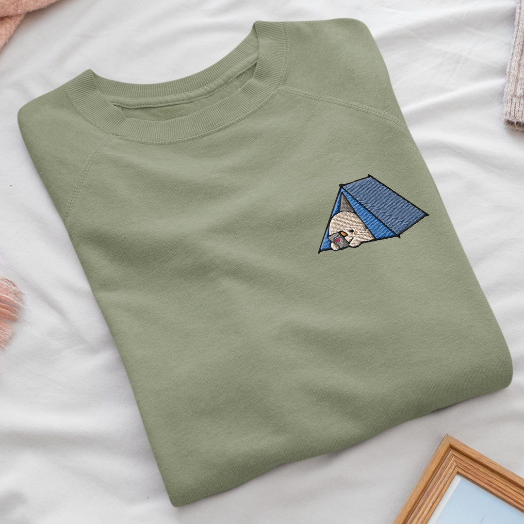 a green t - shirt with a picture of a dog in a tent on it