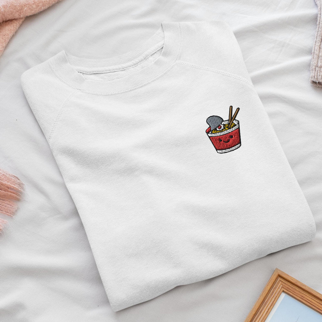 a white t - shirt with a picture of a bowl of noodles and chopstick