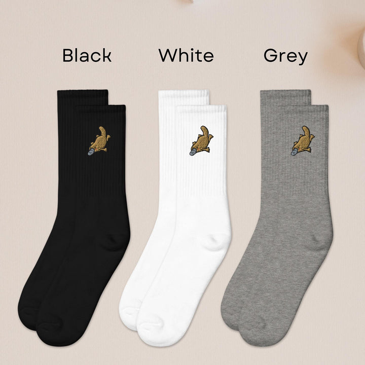 three pairs of black, white, and grey socks