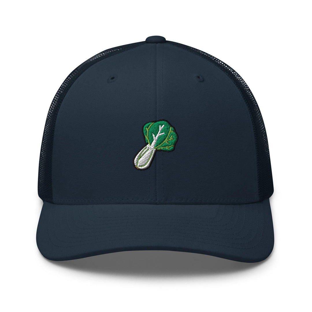 a blue trucker hat with a green leaf on it