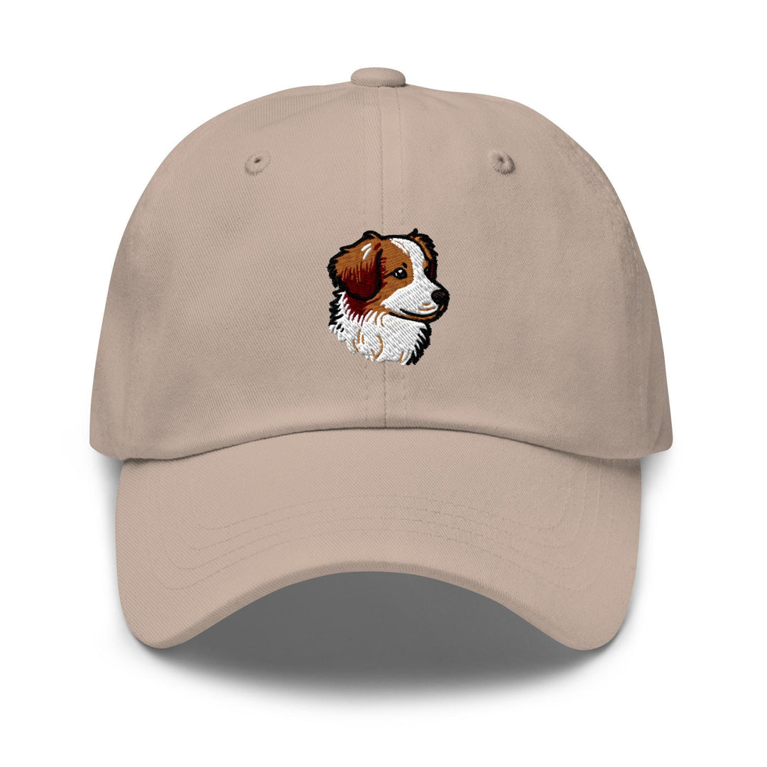 a tan hat with a brown and white dog on it