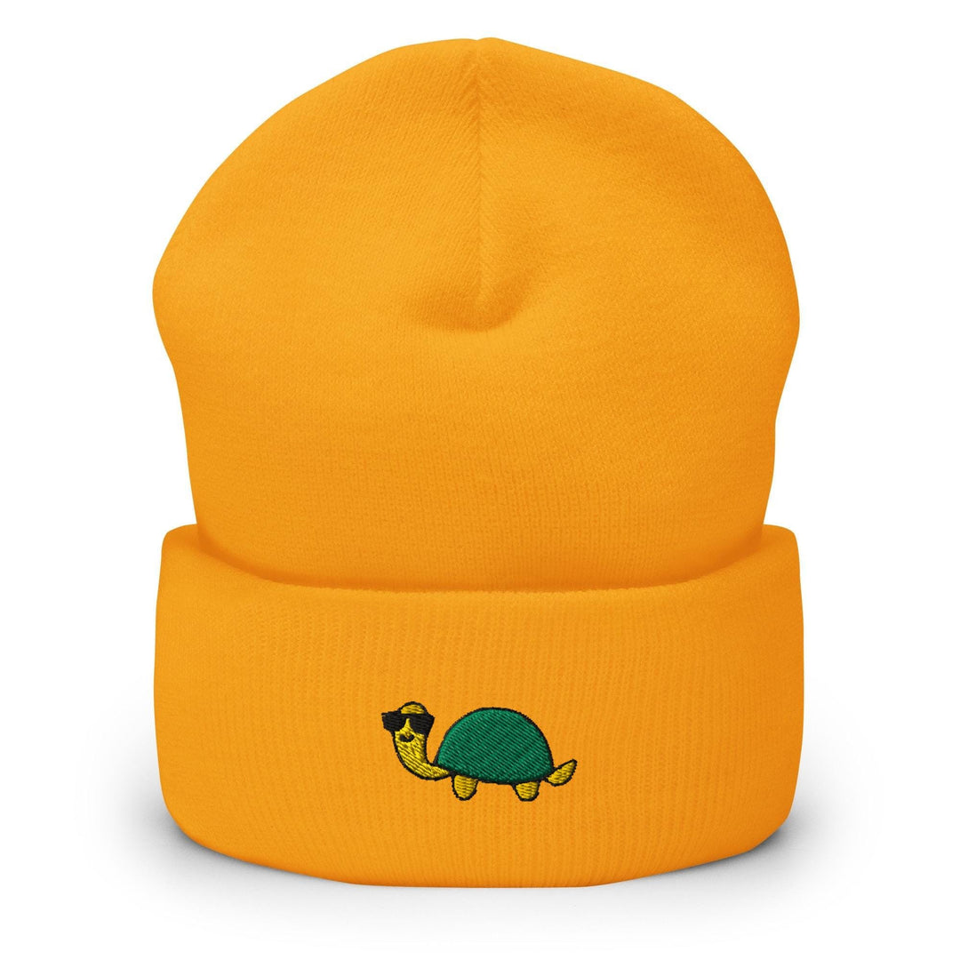 a yellow beanie with a turtle on it