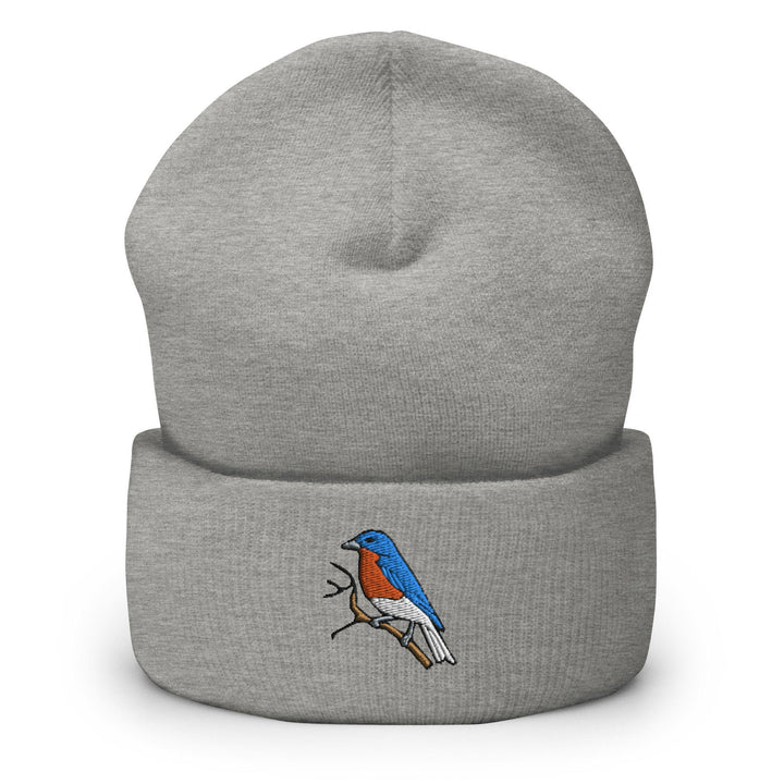 a grey beanie with a red and blue bird on it