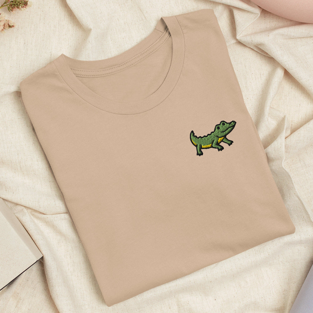 a t - shirt with a picture of a crocodile on it