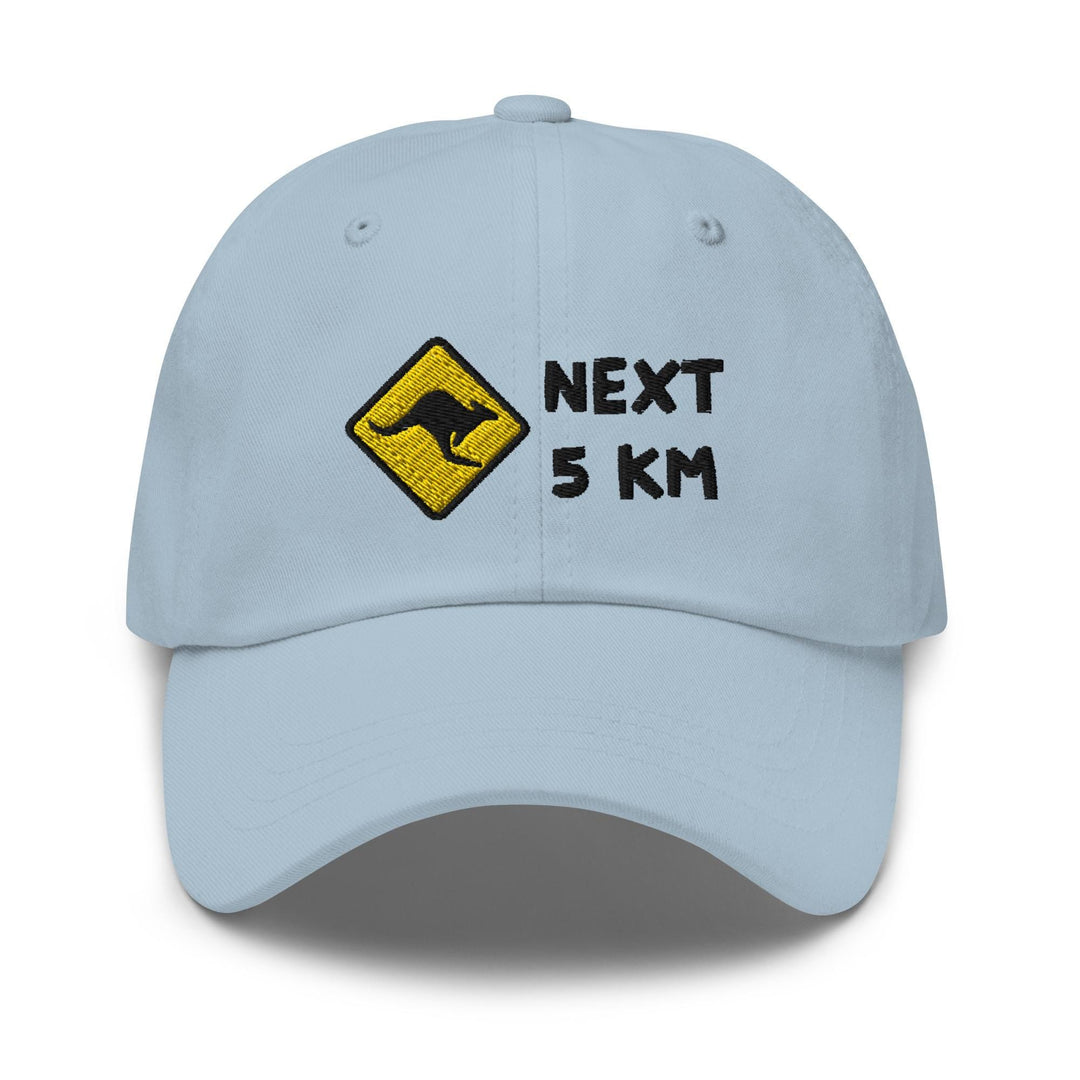 a light blue hat with the words next 5 km printed on it