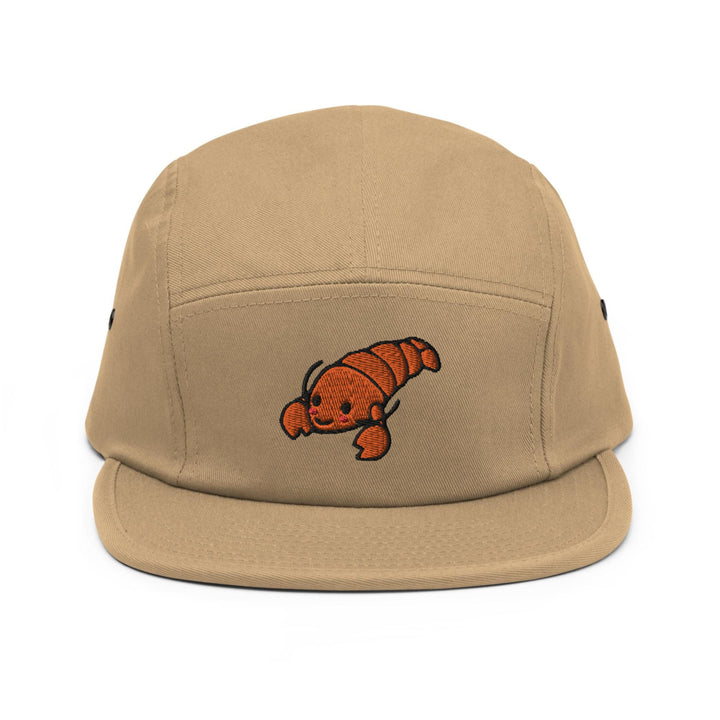 a brown hat with an orange fish embroidered on it