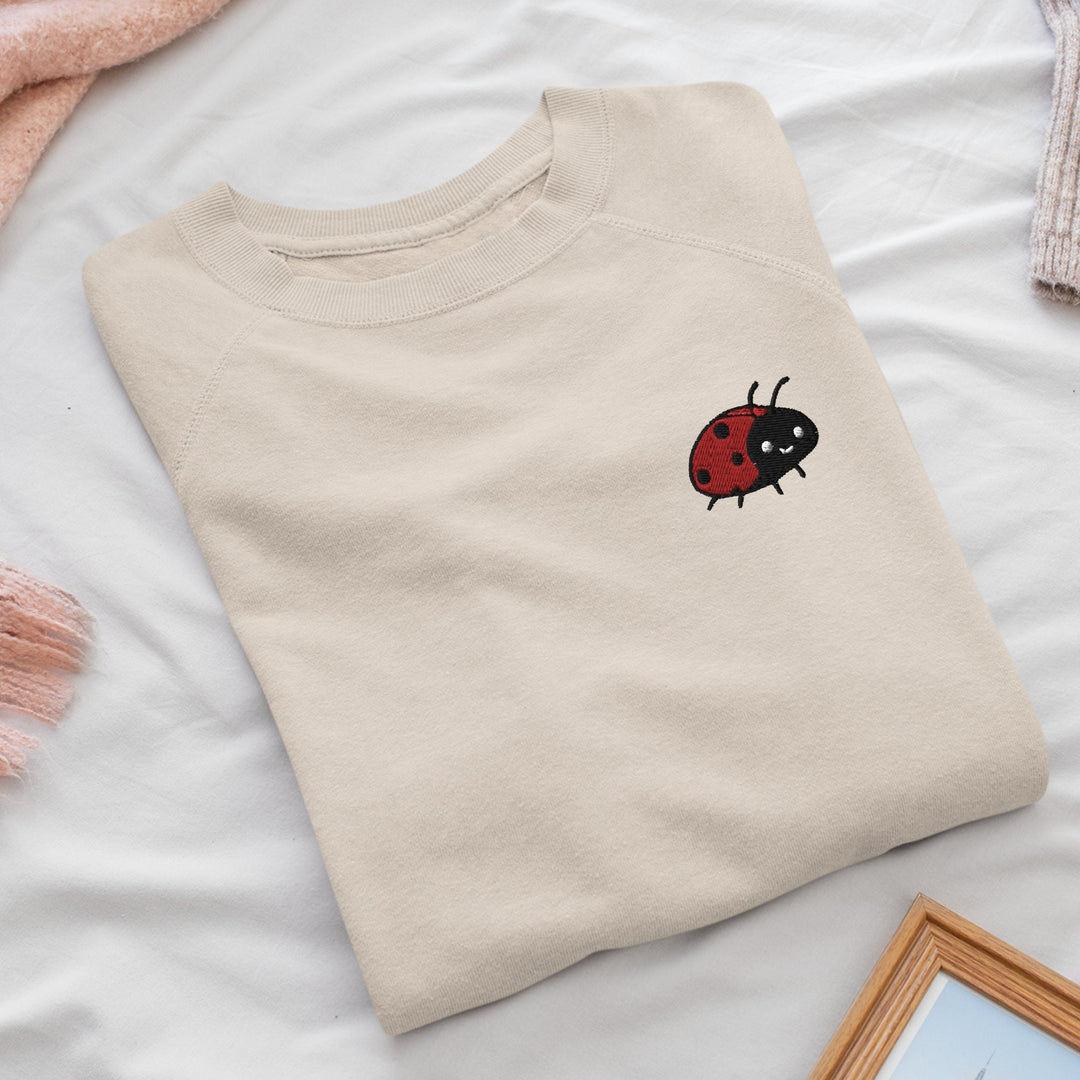 a t - shirt with a ladybug embroidered on it