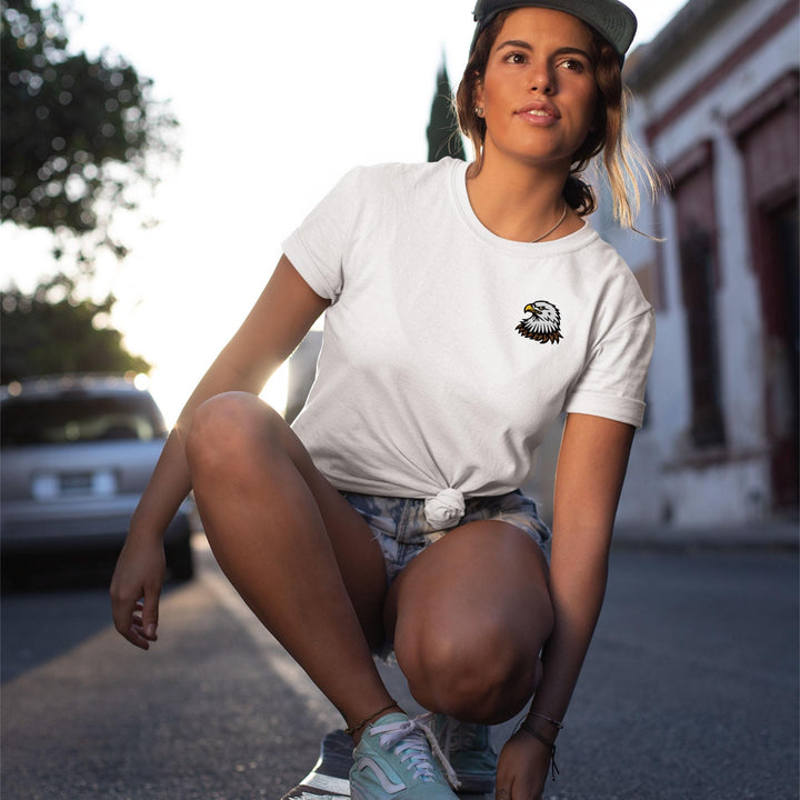 a woman kneeling down on a skateboard on the street
