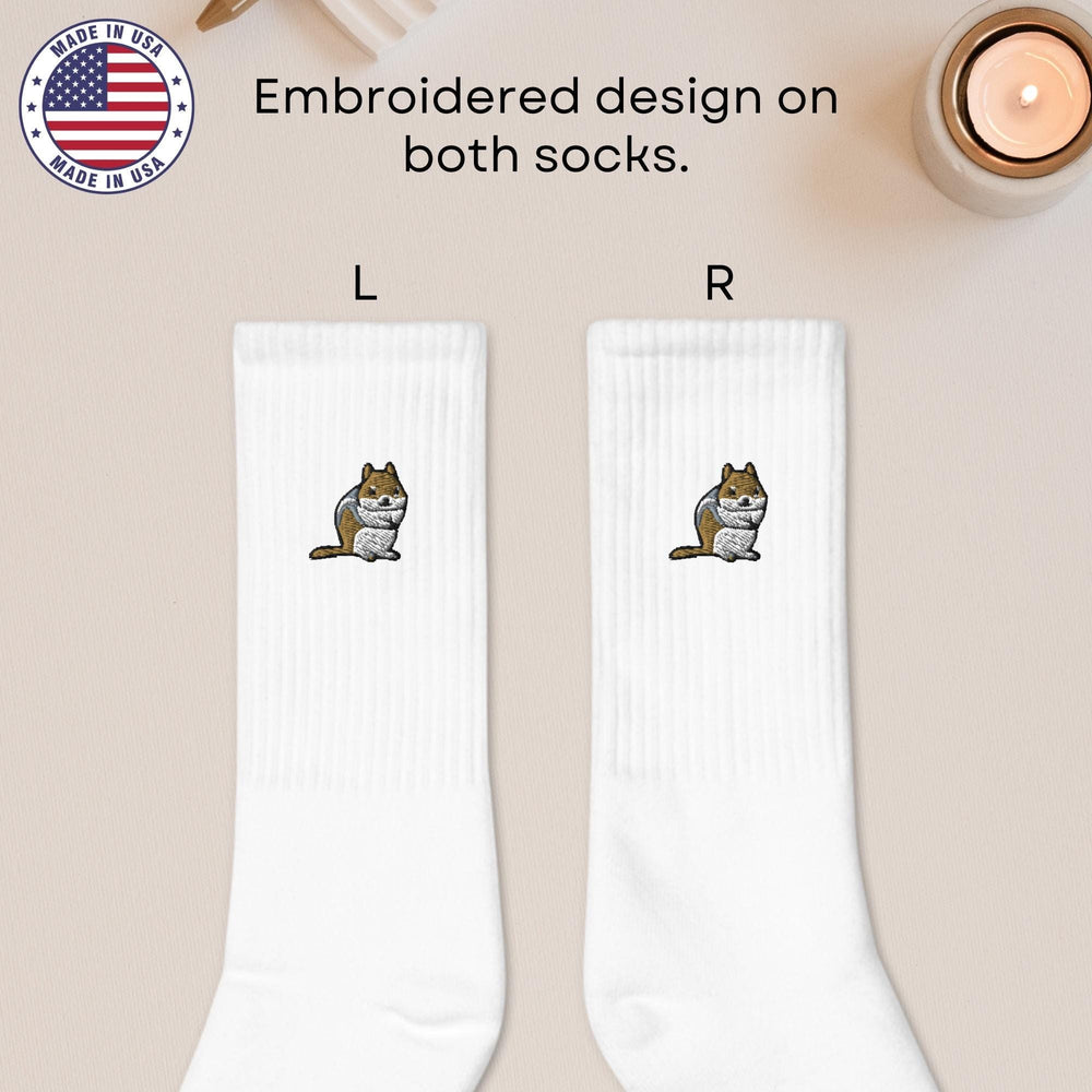 a pair of white socks with a cartoon cat on it
