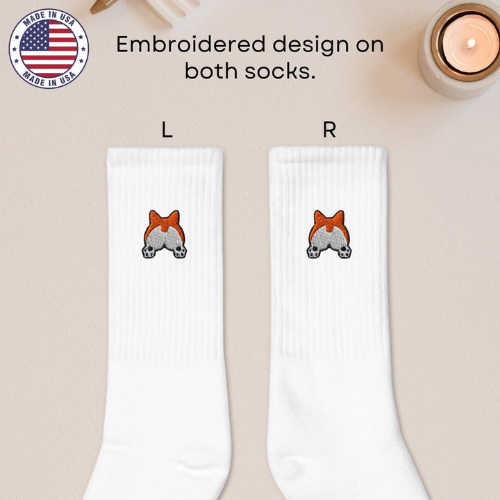 a pair of white socks with a red bow on them