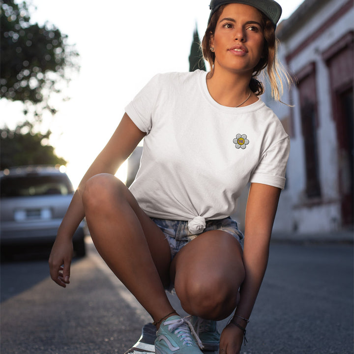 a woman kneeling down on a skateboard on the street
