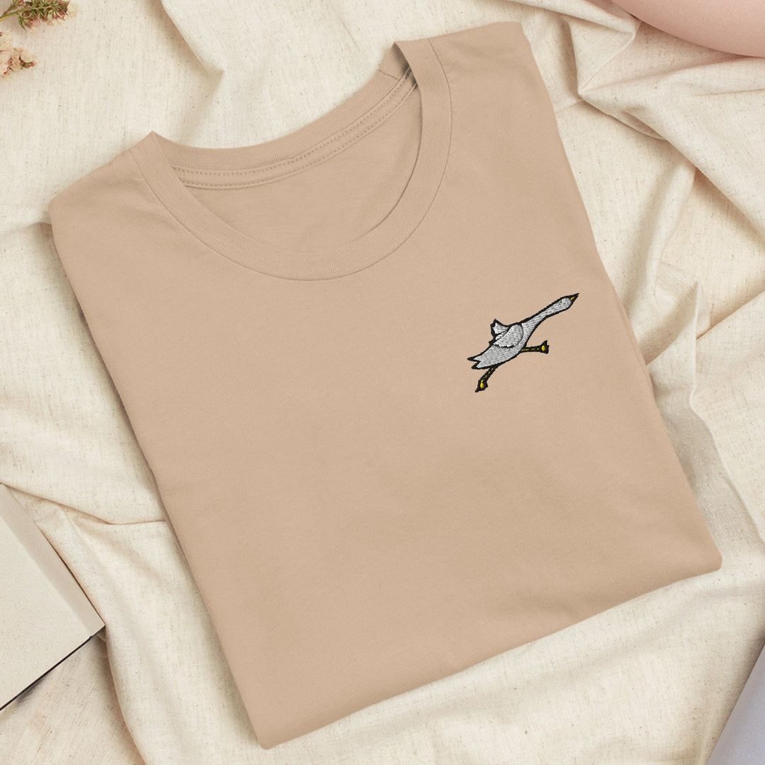 a t - shirt with a picture of a bird on it
